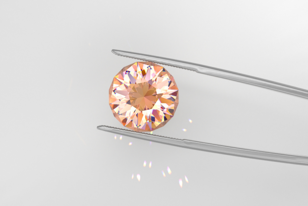 A pair of tweezers holding a 2ct round cut padparadscha sapphire.