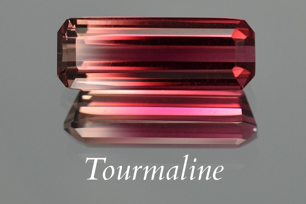 A bi-color pink and orange tourmaline on the text: Tourmalines