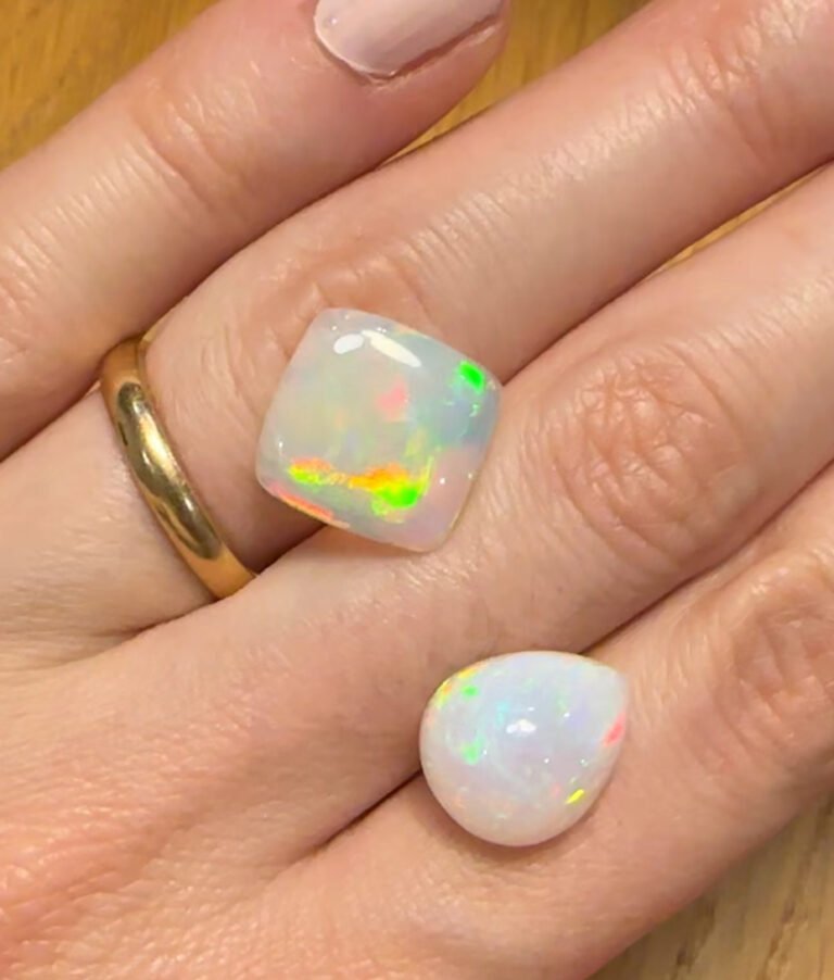 TTwo opals on my hand to show difference in size and compare the color for a jewellery piece prospect.