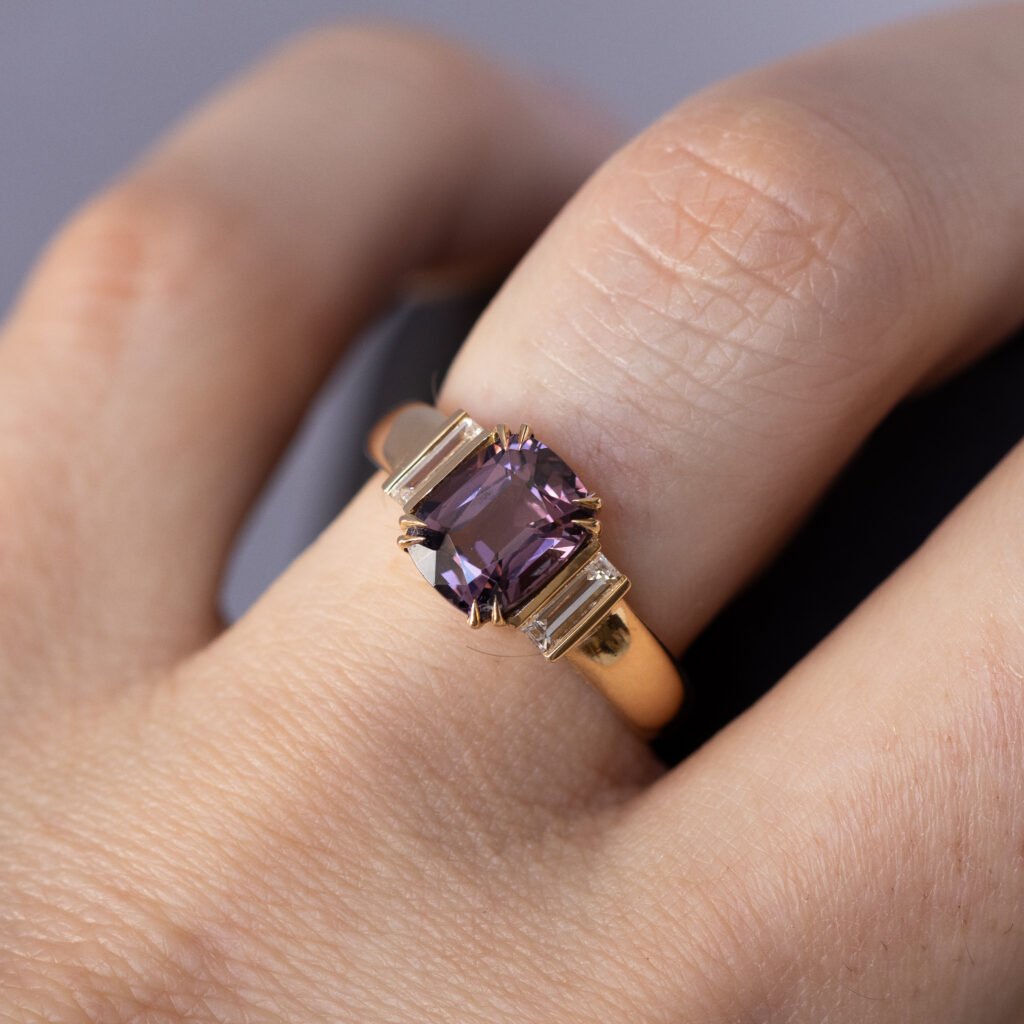 1908, featuring a 2.02ct purplish pink spinel from Tanzania and 0.30ct baguette diamonds, F color, VS. Set in 18k gold.